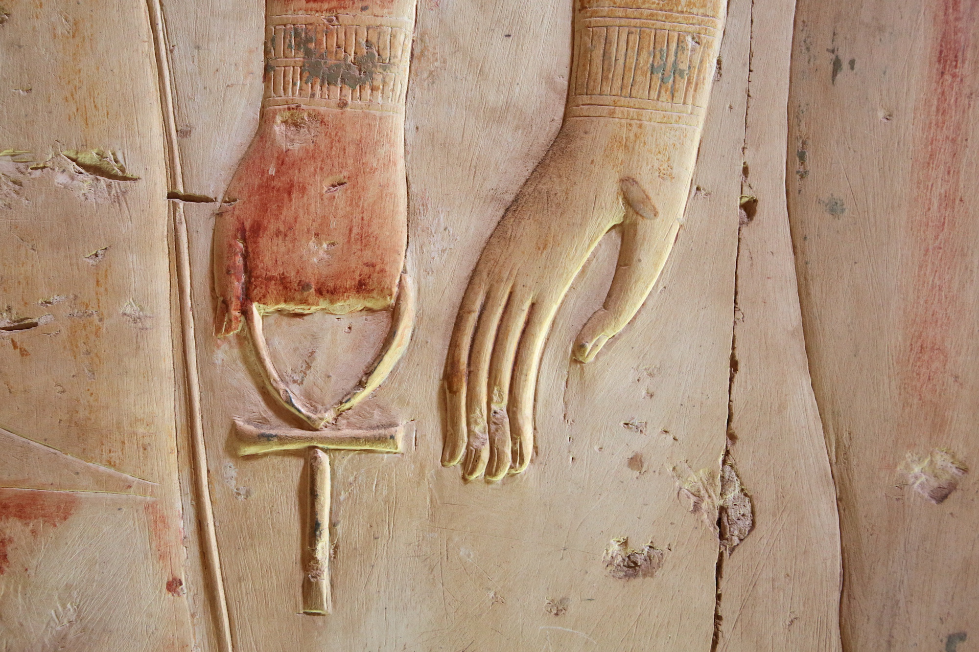 Hand holding an ankh cross
